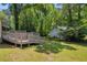 Backyard and lawn areas feature a deck, sheds, and mature shade trees at 15 Porter Cir, Hampton, GA 30228