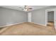 Spacious bedroom with neutral walls and a ceiling fan for added comfort at 15 Porter Cir, Hampton, GA 30228