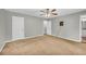 Large bedroom with two entry doors, neutral walls and a ceiling fan at 15 Porter Cir, Hampton, GA 30228