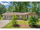 Traditional-style home with a well-maintained lawn and mature trees at 15 Porter Cir, Hampton, GA 30228