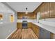 Well-lit kitchen featuring wooden cabinets, stainless steel appliances, and a stylish white backsplash at 15 Porter Cir, Hampton, GA 30228