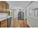 Bright kitchen and dining area featuring a stainless steel refrigerator and wood-look flooring at 15 Porter Cir, Hampton, GA 30228