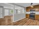 Open-concept layout showcasing a kitchen with stainless steel appliances connected to the living area at 15 Porter Cir, Hampton, GA 30228