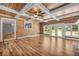 Bright living room featuring wood paneling, a decorative beamed ceiling, and French doors at 15 Porter Cir, Hampton, GA 30228