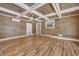 Spacious living room featuring wood paneling and a striking coffered ceiling design at 15 Porter Cir, Hampton, GA 30228