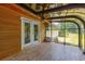 Enclosed sunroom with wood-look tile flooring and ceiling fan at 15 Porter Cir, Hampton, GA 30228