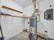 Utility area features a water heater, shelving, and electrical panel at 15 Porter Cir, Hampton, GA 30228