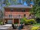 Rear elevation showcasing a large yard with firepit and patio, mature trees, and deck above at 2270 Emerald Dr, Jonesboro, GA 30236