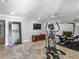 Basement gym with a full length mirror and a home gym setup. Includes tile flooring at 2270 Emerald Dr, Jonesboro, GA 30236