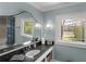 Stylish bathroom featuring a granite countertop, elegant fixtures, and a window view at 2270 Emerald Dr, Jonesboro, GA 30236