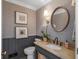 Beautifully appointed powder room with wainscoting, designer wallpaper, elegant fixtures, and a stylish vanity at 2270 Emerald Dr, Jonesboro, GA 30236