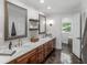 Beautiful bathroom featuring dual sinks, marble countertops, wood cabinets and floors, and modern fixtures at 2270 Emerald Dr, Jonesboro, GA 30236