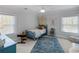 Charming bedroom featuring two windows and a blue accent chair at 2270 Emerald Dr, Jonesboro, GA 30236