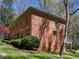 Traditional brick home featuring lush lawn, mature trees, and a side deck at 2270 Emerald Dr, Jonesboro, GA 30236