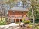 Rear exterior view showing back of brick house, two-car garage and grassy area at 2270 Emerald Dr, Jonesboro, GA 30236