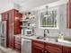 Well-equipped kitchen with stainless steel appliances, granite countertops, custom cabinets, and a view to the outside at 2270 Emerald Dr, Jonesboro, GA 30236