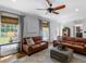 Cozy living room with hardwood floors, large windows, comfortable seating, and seamless transition to other living spaces at 2270 Emerald Dr, Jonesboro, GA 30236