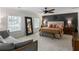 Spacious main bedroom featuring a king bed, large windows, and a sitting area with a comfortable sofa at 2270 Emerald Dr, Jonesboro, GA 30236