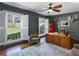 Inviting home office with hardwood floors, grey walls, white shutters, and a ceiling fan for a cozy work environment at 2270 Emerald Dr, Jonesboro, GA 30236