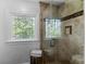 Elegant shower with glass door and window, tiled walls, and a built-in soap and shampoo niche at 2270 Emerald Dr, Jonesboro, GA 30236