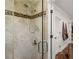 Lovely shower room with decorative tile, glass door, and chrome showerhead at 2270 Emerald Dr, Jonesboro, GA 30236