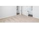 A carpeted bedroom with white walls has an open doorway to the hallway and another to the bathroom at 624 Devon Aly, Acworth, GA 30102