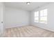 A bright bedroom with neutral carpet, natural light from two windows, and fresh, light-colored walls at 624 Devon Aly, Acworth, GA 30102