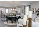 Open-concept living area with a modern chandelier, dining, and kitchen view at 624 Devon Aly, Acworth, GA 30102
