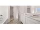 Bright bathroom featuring double vanity, white cabinets, tub, and updated fixtures at 712 Curb Ct, Locust Grove, GA 30248