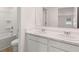 Bathroom with white countertops, double sinks, and a shower-tub combo at 712 Curb Ct, Locust Grove, GA 30248
