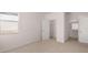 Bedroom featuring carpet flooring, large window, closet, and bathroom entrance at 712 Curb Ct, Locust Grove, GA 30248