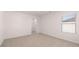 Bedroom featuring carpet flooring, large window, closet, and doorway at 712 Curb Ct, Locust Grove, GA 30248