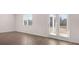 Bright living room with hardwood floors and access to backyard through glass doors at 712 Curb Ct, Locust Grove, GA 30248