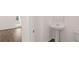Stylish powder room with pedestal sink and modern fixtures at 712 Curb Ct, Locust Grove, GA 30248