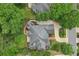 Bird's-eye view of a house with a well-maintained roof, garden, and stone driveway at 8250 Saint Marlo Fairway Dr, Duluth, GA 30097