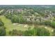 Wide aerial view of a golf course and residential community featuring mature trees and a pond at 8250 Saint Marlo Fairway Dr, Duluth, GA 30097