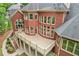 Brick home with a large back deck, showcasing multiple windows and architectural details at 8250 Saint Marlo Fairway Dr, Duluth, GA 30097
