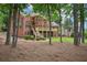 Brick home with a deck surrounded by mature trees and a well-manicured lawn at 8250 Saint Marlo Fairway Dr, Duluth, GA 30097