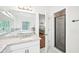 Bright bathroom with granite counters and a frameless glass shower at 8250 Saint Marlo Fairway Dr, Duluth, GA 30097