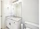 Bathroom with a granite countertop, white cabinets, tile flooring, and decorative light fixtures at 8250 Saint Marlo Fairway Dr, Duluth, GA 30097