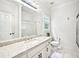Bathroom with a glass shower door, granite countertop, white cabinets, and tile floors at 8250 Saint Marlo Fairway Dr, Duluth, GA 30097