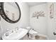 Classic half-bath with decorative wall art, tile floors, and sink with a brass faucet at 8250 Saint Marlo Fairway Dr, Duluth, GA 30097
