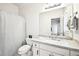 Bathroom with a granite countertop, white cabinets, a shower with a curtain, and a large mirror at 8250 Saint Marlo Fairway Dr, Duluth, GA 30097