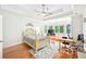 Light filled bedroom with hardwood floors and a tray ceiling at 8250 Saint Marlo Fairway Dr, Duluth, GA 30097