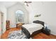 Bright bedroom with vaulted ceilings, a large window, and hardwood floors showcases an inviting space at 8250 Saint Marlo Fairway Dr, Duluth, GA 30097