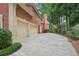 Spacious three car garage and long driveway leading to a beautiful brick home at 8250 Saint Marlo Fairway Dr, Duluth, GA 30097
