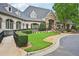 The clubhouse is elegantly designed with stone accents, arched windows, and beautiful landscaping at 8250 Saint Marlo Fairway Dr, Duluth, GA 30097