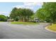Community entrance with lush landscaping, sidewalks, and a peek at the lake and gazebo at 8250 Saint Marlo Fairway Dr, Duluth, GA 30097