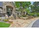 The clubhouse is elegantly designed with stone accents, arched windows, and beautiful landscaping at 8250 Saint Marlo Fairway Dr, Duluth, GA 30097