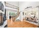 Spacious foyer with hardwood floors, staircase, and view of the dining room at 8250 Saint Marlo Fairway Dr, Duluth, GA 30097